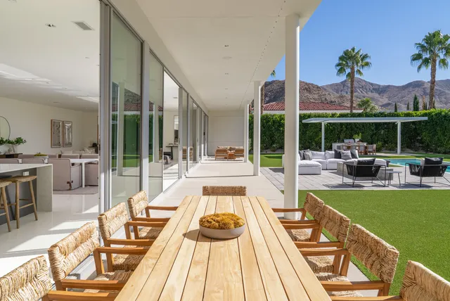 a view of a house with swimming pool and sitting area