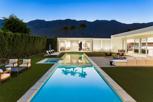 a view of a house with a swimming pool and a porch