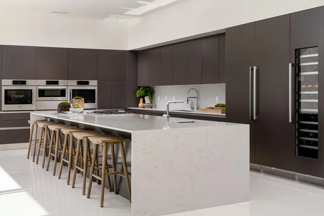 a kitchen with a refrigerator and a stove top oven