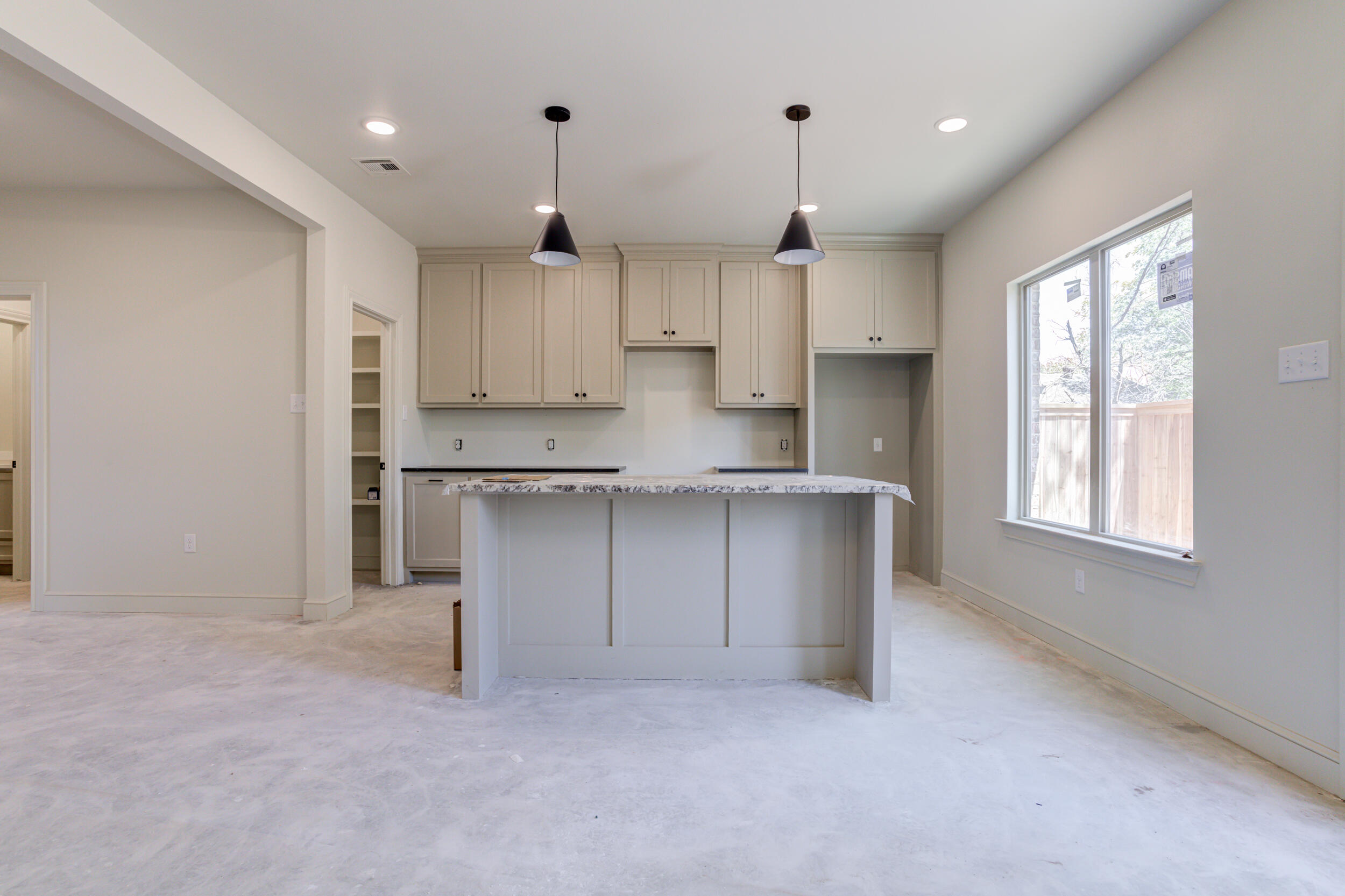 3425 24th Street Lubbock, TX 79410 - Photo 16 of 45 an empty room with kitchen view and wooden floor