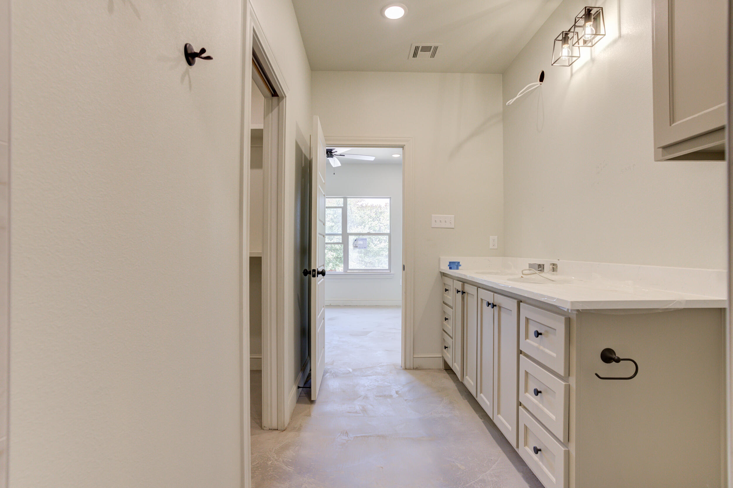 3425 24th Street Lubbock, TX 79410 - Photo 30 of 45 a bathroom with a double vanity sink a toilet and shower