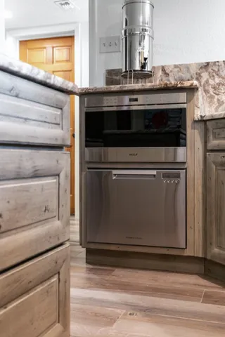 a stove top oven sitting inside of a kitchen