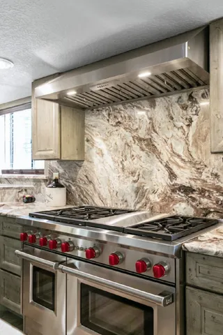 a stove top oven sitting inside of a kitchen