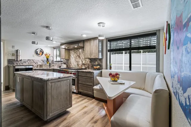 a kitchen with stainless steel appliances granite countertop a stove and a refrigerator