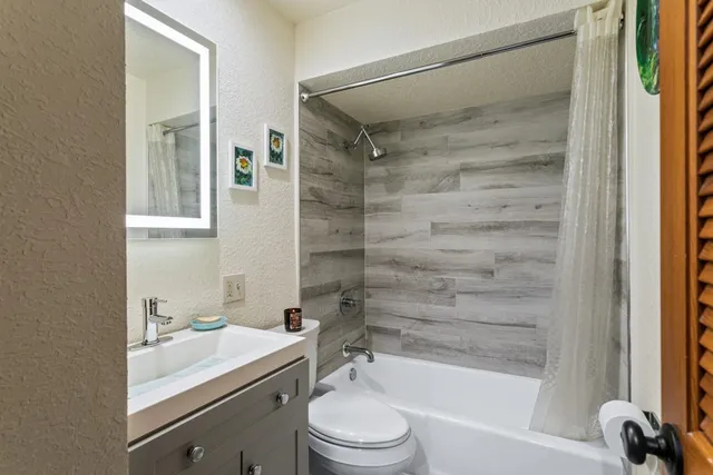a bathroom with a sink toilet and shower