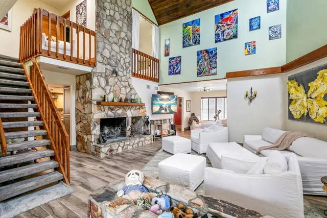 a picture of a living room with furniture and a fireplace