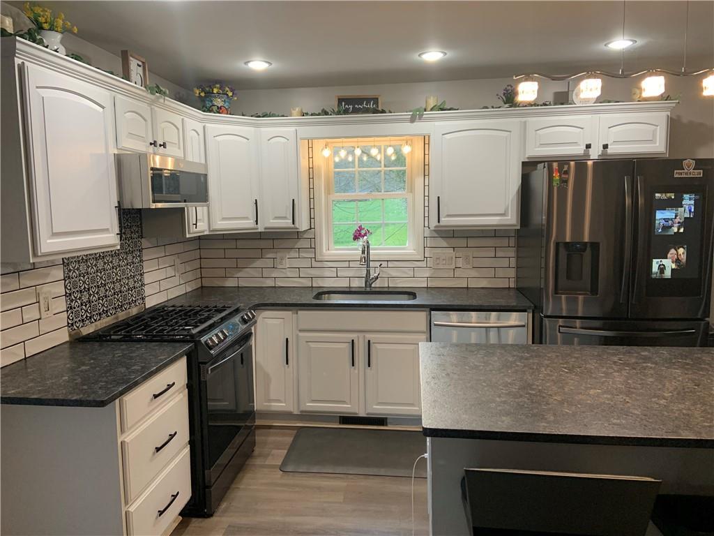 1217 Sarver Road Sarver, PA 16055 - Photo 2 of 23 a kitchen with stainless steel appliances granite countertop a sink and a stove