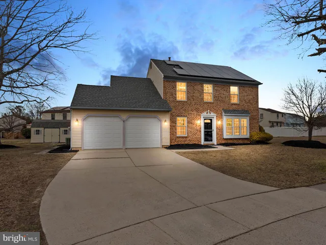 a front view of a house with yard and garage