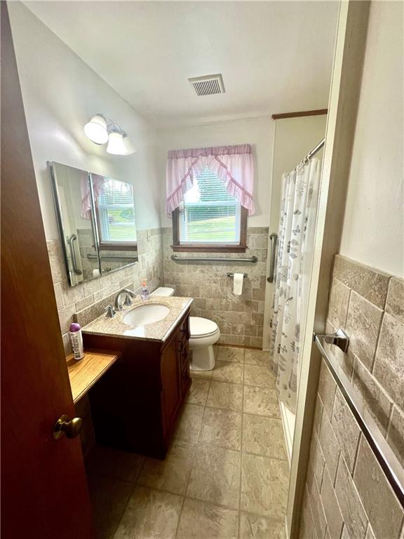 1215 Pittsburgh Road Uniontown, PA 15401 - Photo 21 of 39 a bathroom with a sink mirror vanity and toilet
