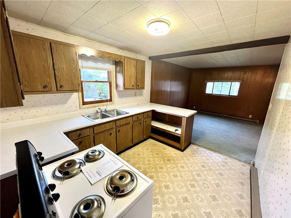 1215 Pittsburgh Road Uniontown, PA 15401 - Photo 34 of 39 a kitchen with a stove a sink and a refrigerator