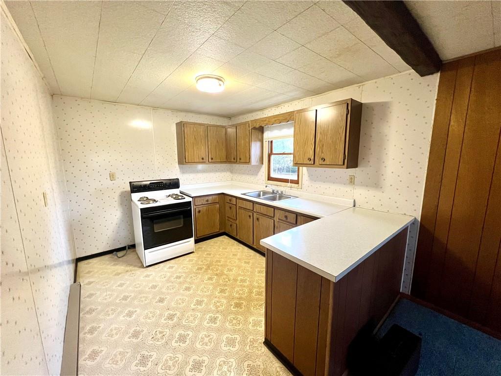 1215 Pittsburgh Road Uniontown, PA 15401 - Photo 35 of 39 a kitchen with stainless steel appliances granite countertop a sink stove and refrigerator