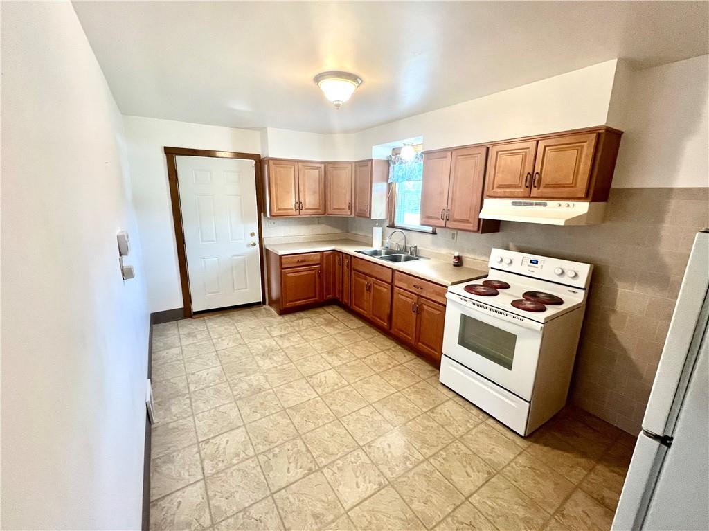 1215 Pittsburgh Road Uniontown, PA 15401 - Photo 8 of 39 a kitchen with a stove a sink and a refrigerator