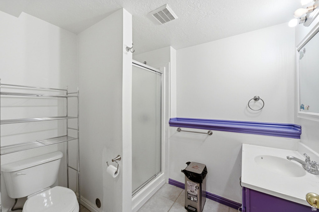 2475 Church Street Layton, UT 84040 - Photo 13 of 27 Bathroom featuring a glass-enclosed shower, single vanity with a white basin, and a toilet