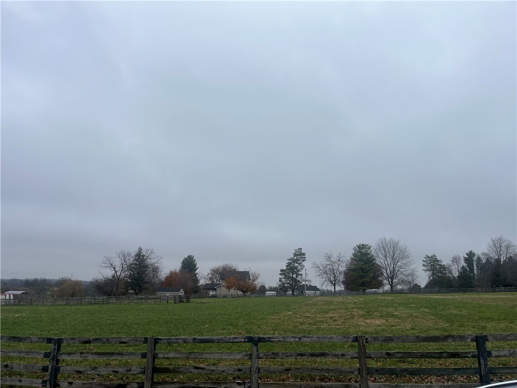 3761 Ferry Road Bellbrook, OH 45305 - Photo 3 of 20 Expansive green pastures stretch under an open sky, offering a serene rural landscape.