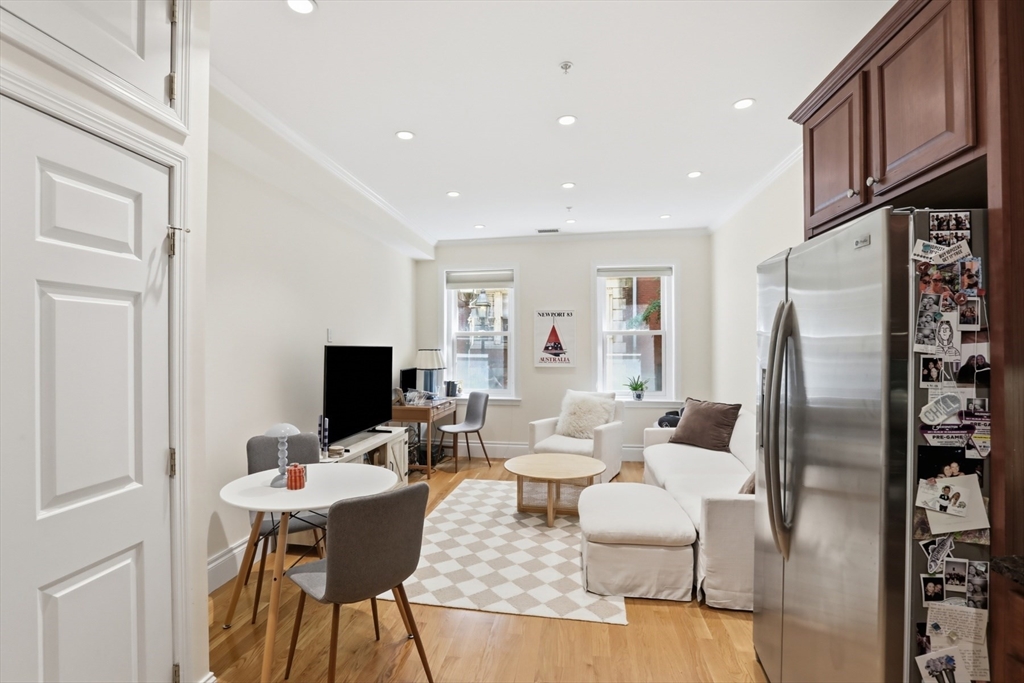 73 Myrtle Street, Unit 2 Boston, MA 02114 - Photo 4 of 13 a living room with fireplace furniture and a flat screen tv