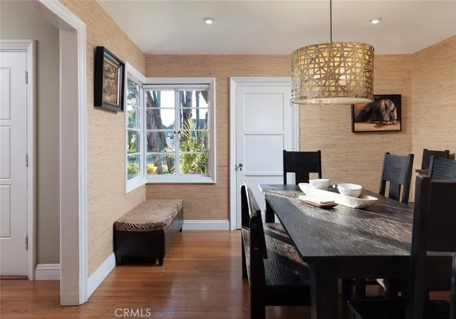 a view of a dining room with furniture wooden floor and chandelier