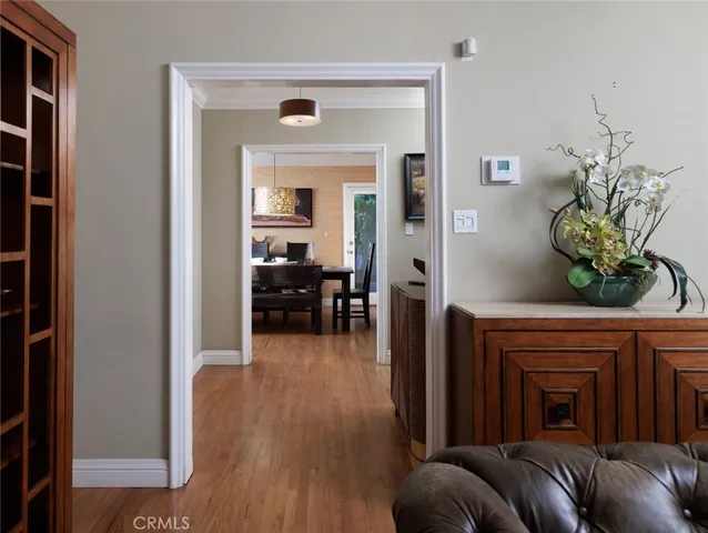 a living room with furniture a fireplace and a potted plant