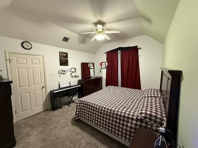 a bed room with a bed and a tv