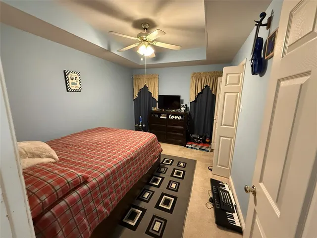 a bedroom with a bed and a flat tv screen
