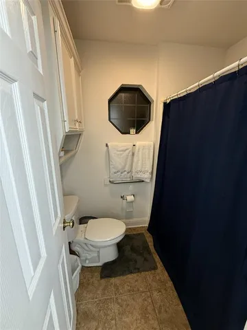 a bathroom with a sink toilet and mirror