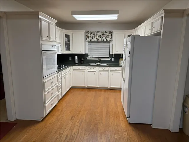 a kitchen with stainless steel appliances a refrigerator and a stove top oven