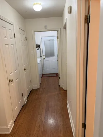 a view of a hallway with wooden floor