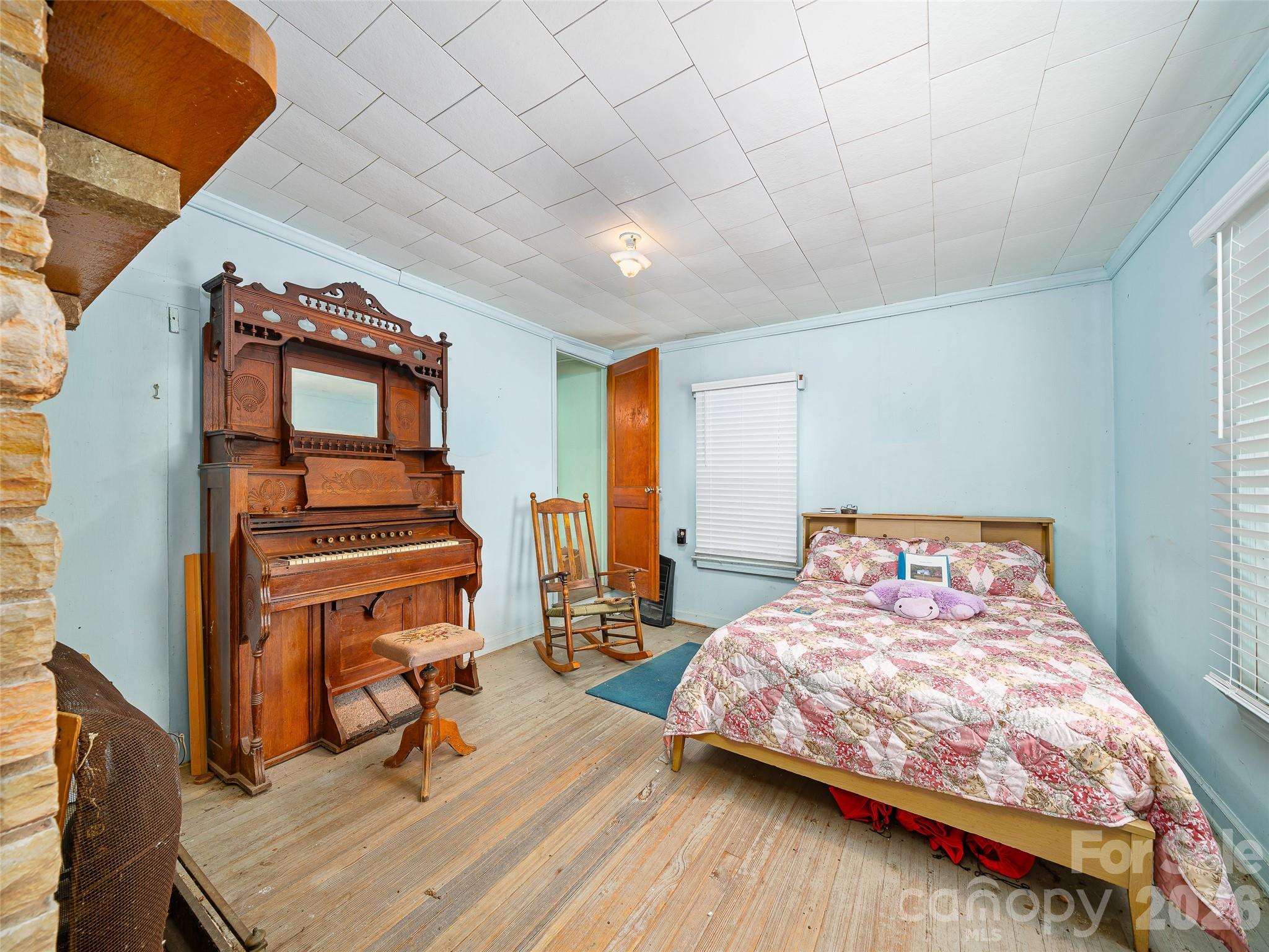 2380 Old Fort Road Black Mountain, NC 28711 - Photo 12 of 27 a bedroom with a bed a dresser and many windows