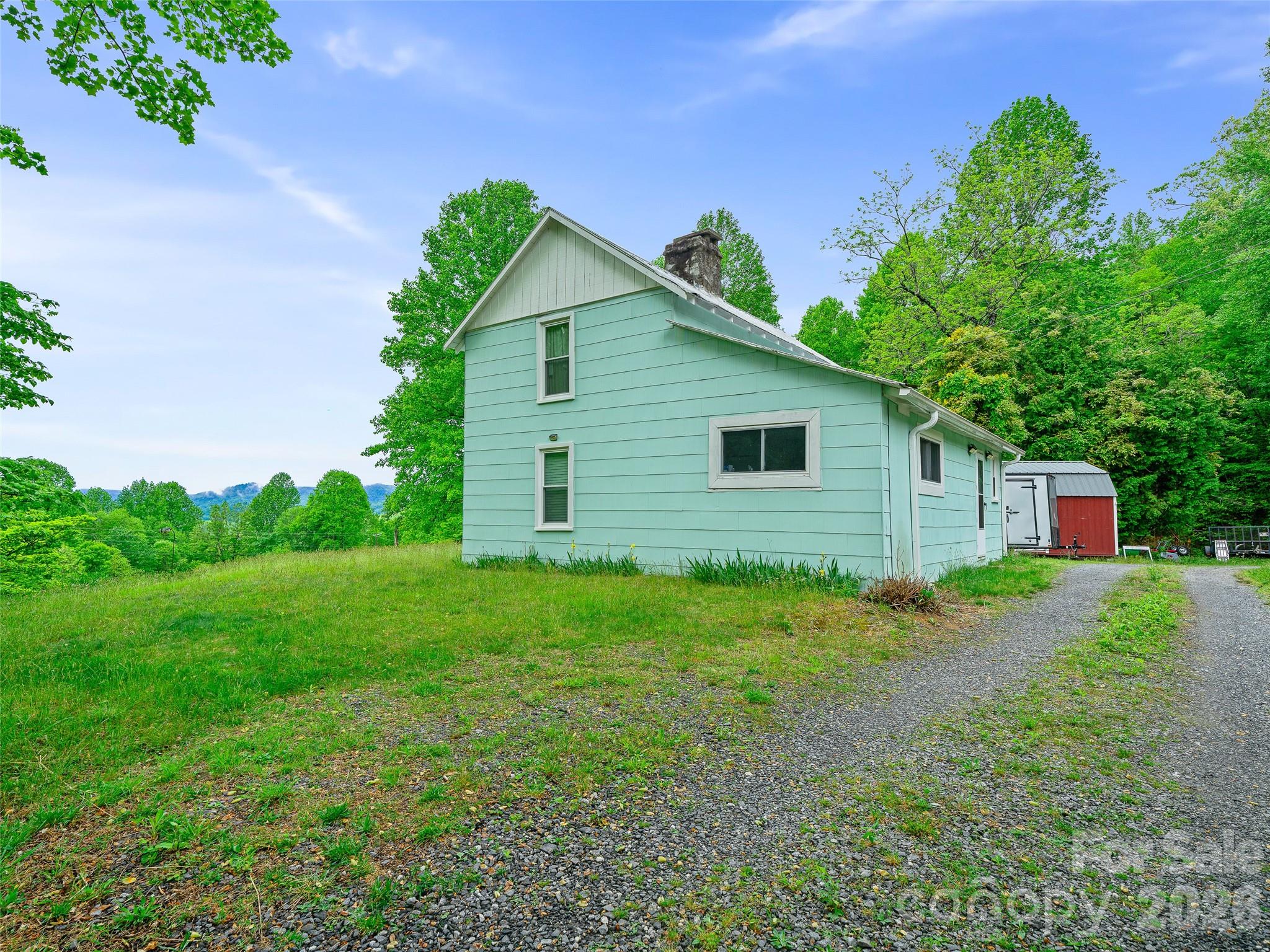2380 Old Fort Road Black Mountain, NC 28711 - Photo 4 of 27 a view of a backyard with potted plants and large tree