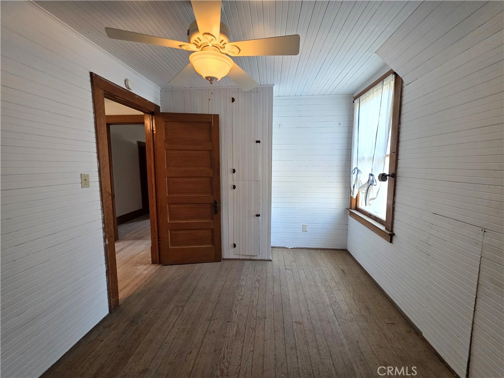 1414 Marin Street Corning, CA 96021 - Photo 21 of 43 wooden floor in an empty room with a window