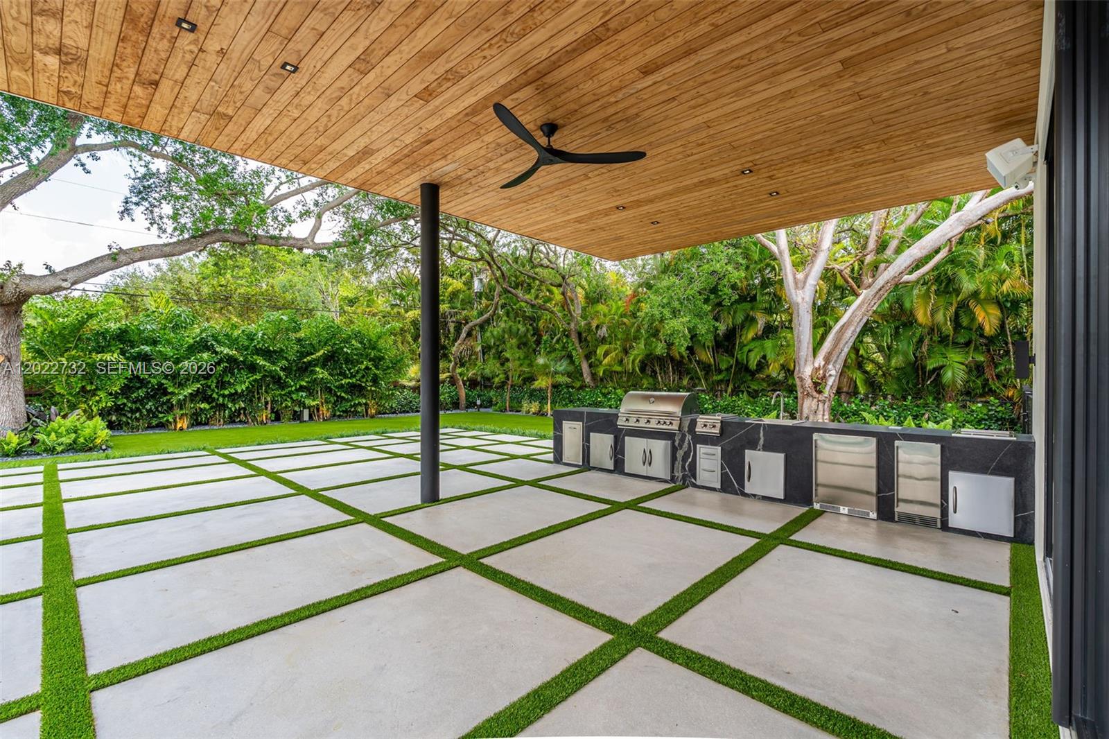 7825 Southwest 128th Street Pinecrest, FL 33156 - Photo 52 of 88 a view of a patio with a table chairs and wooden fence