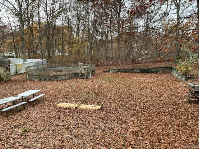 a view of backyard with large trees