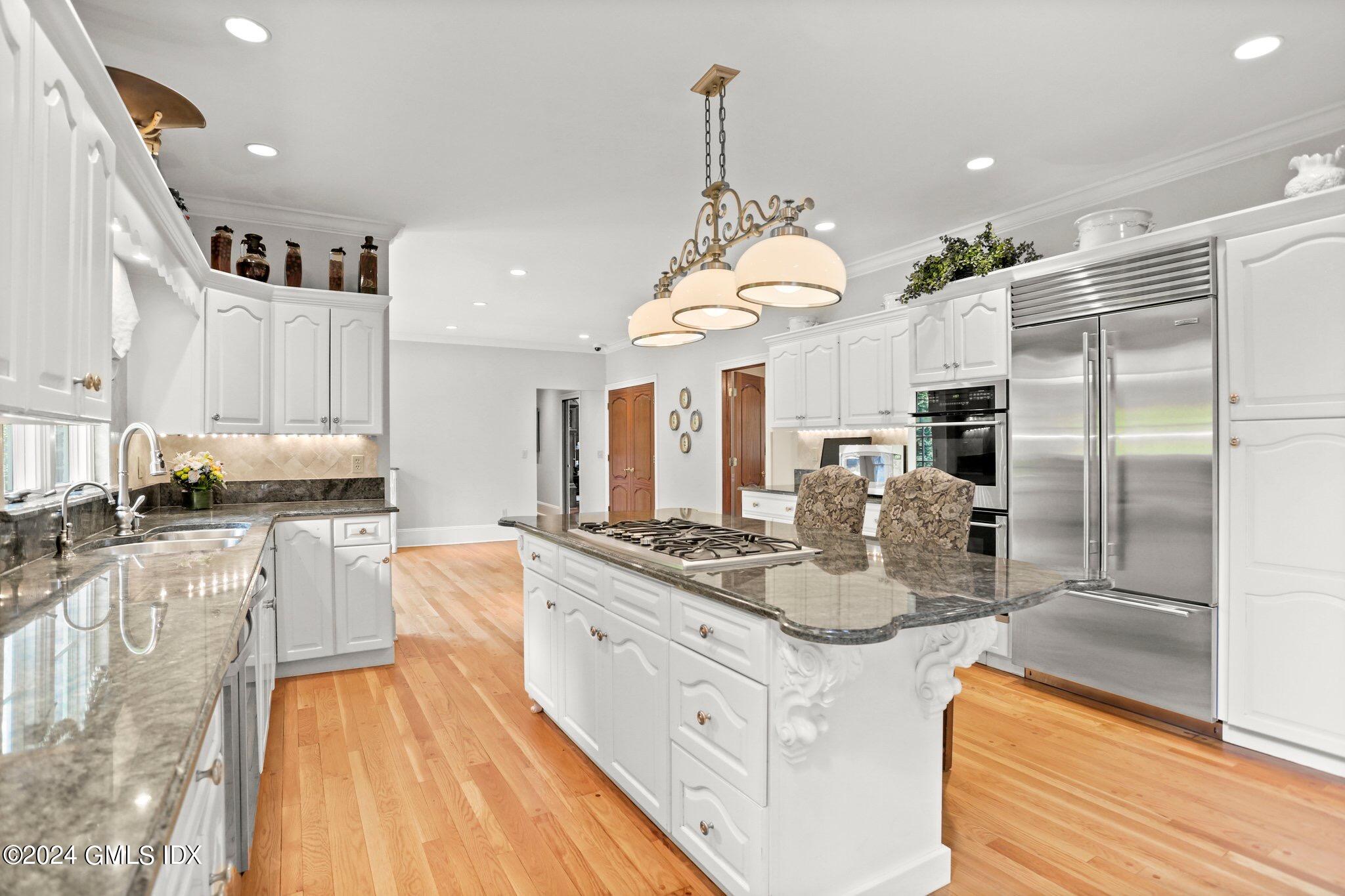 376 Westover Road Stamford, CT 06902 - Photo 13 of 37 a large kitchen with kitchen island a large counter top space a sink stainless steel appliances and cabinets