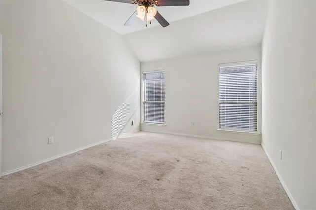 an empty room with a empty space and a ceiling fan