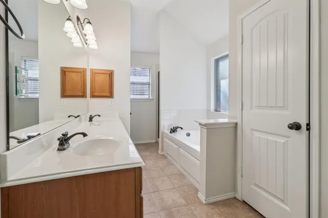 an empty room with chandelier fan