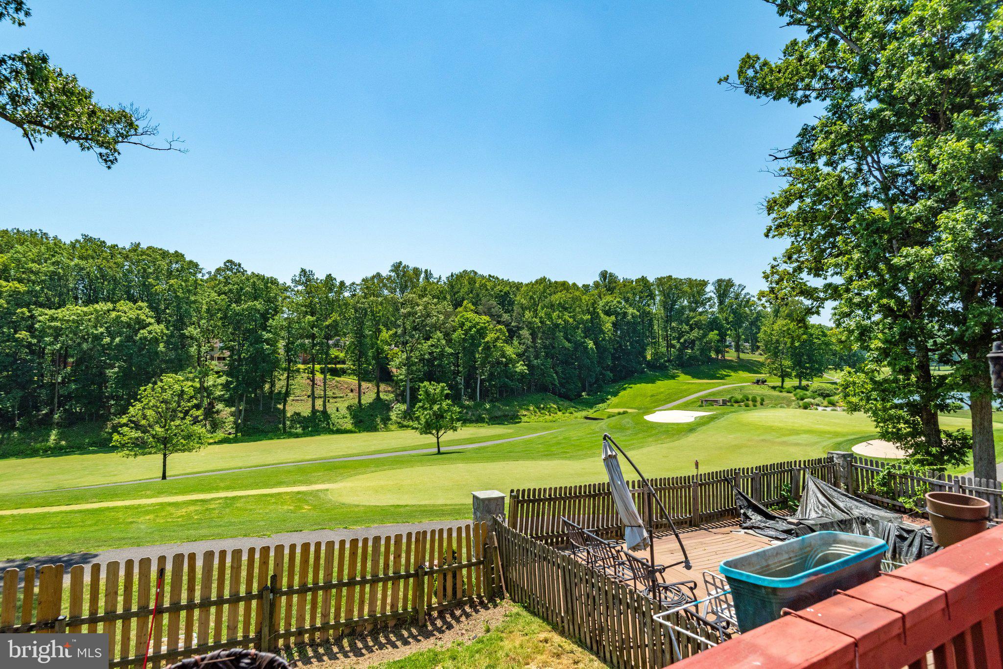 7905 Jansen Court Springfield, VA 22152 - Photo 2 of 26 a view of a swimming pool with lawn chairs under an umbrella