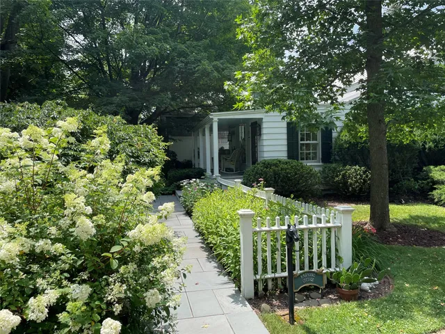 a front view of a house with a yard table and chairs