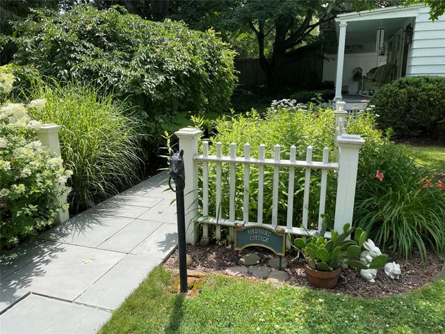a view of a chair and table in the garden