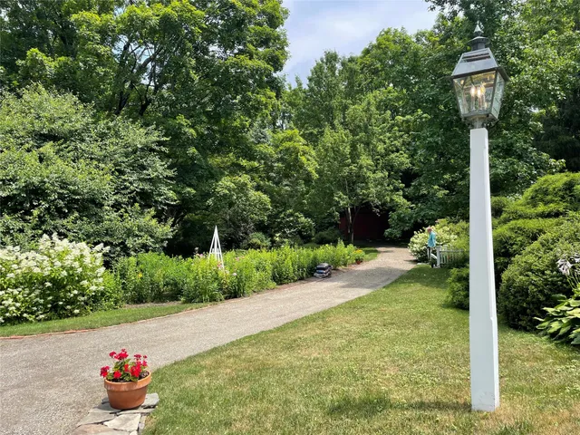 a front view of a house with yard and outdoor seating