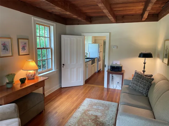 a living room with furniture rug and wooden floor