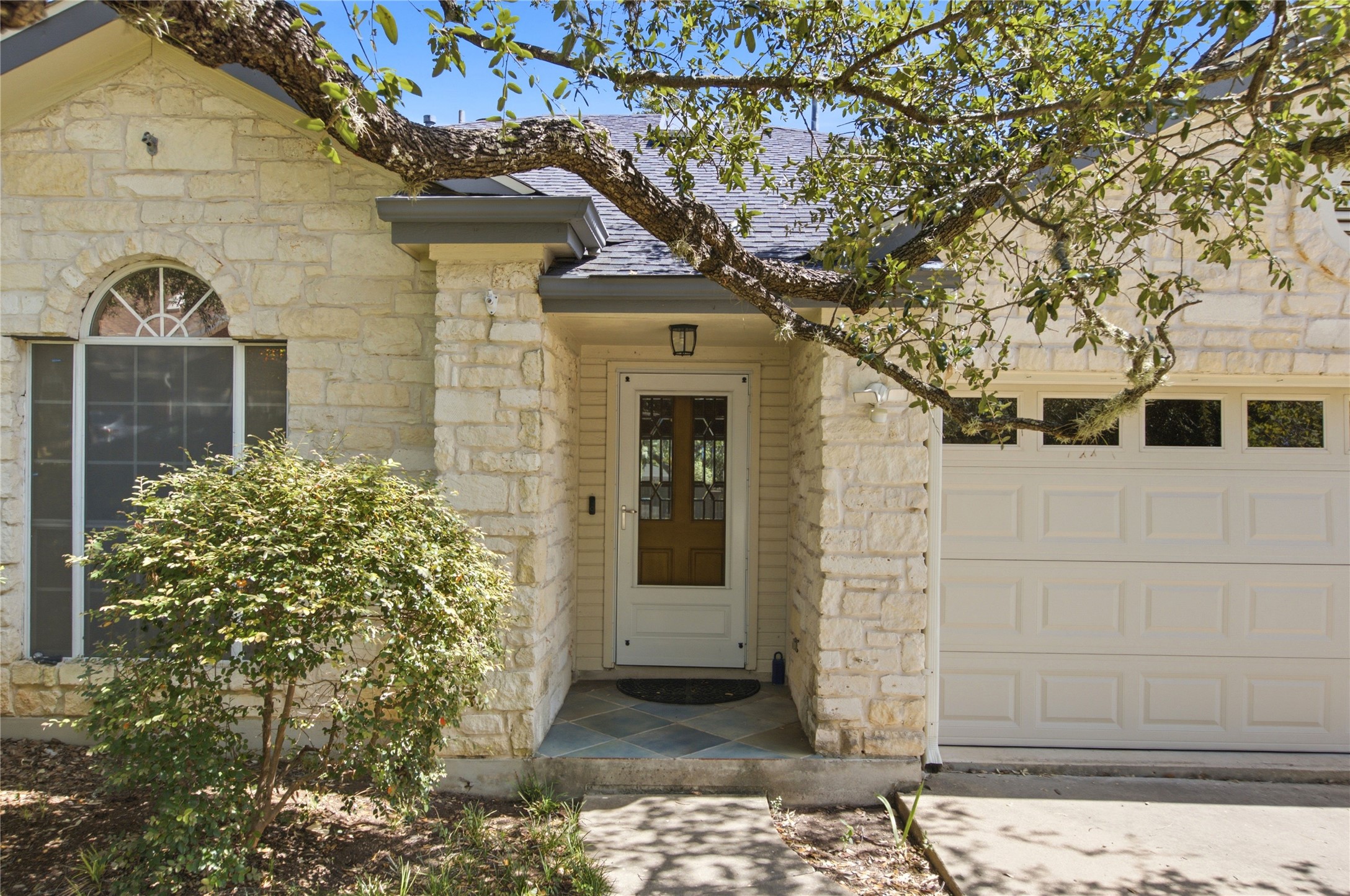 6032 Roxbury Lane Austin, TX 78739 - Photo 2 of 34 A stone facade and arched window accent the inviting entryway of this single-level home.