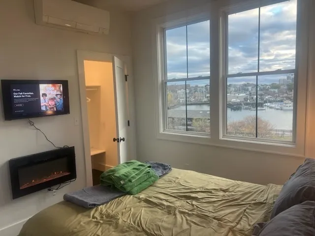 a bedroom with a bed and a window