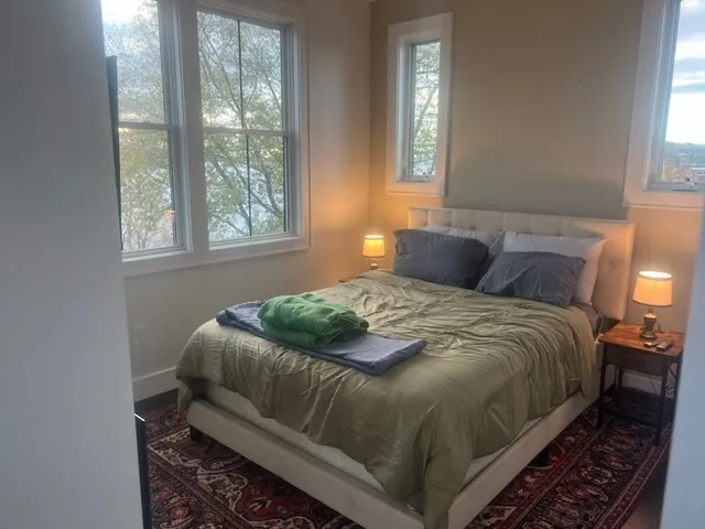 a bedroom with a bed and window
