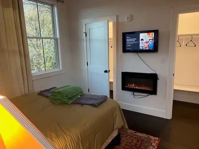 a bedroom with a bed and a flat screen tv