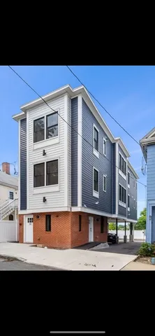 a front view of a building with a yard