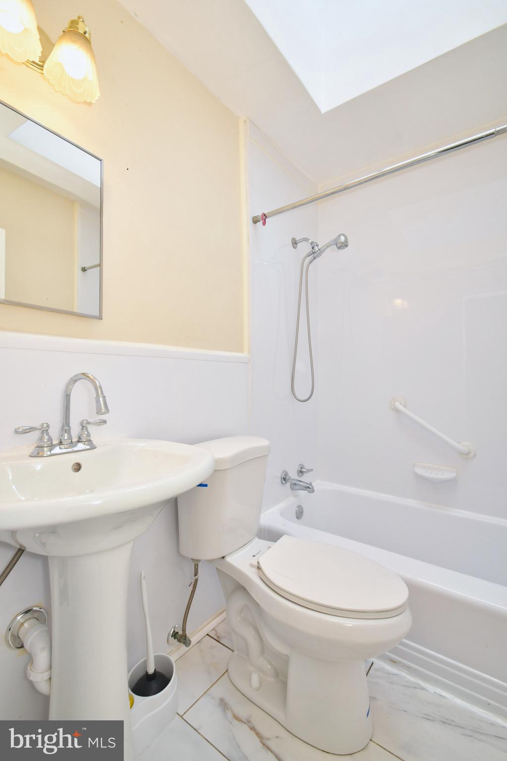 731 Roundview Road Baltimore, MD 21225 - Photo 25 of 40 a bathroom with a sink toilet and shower