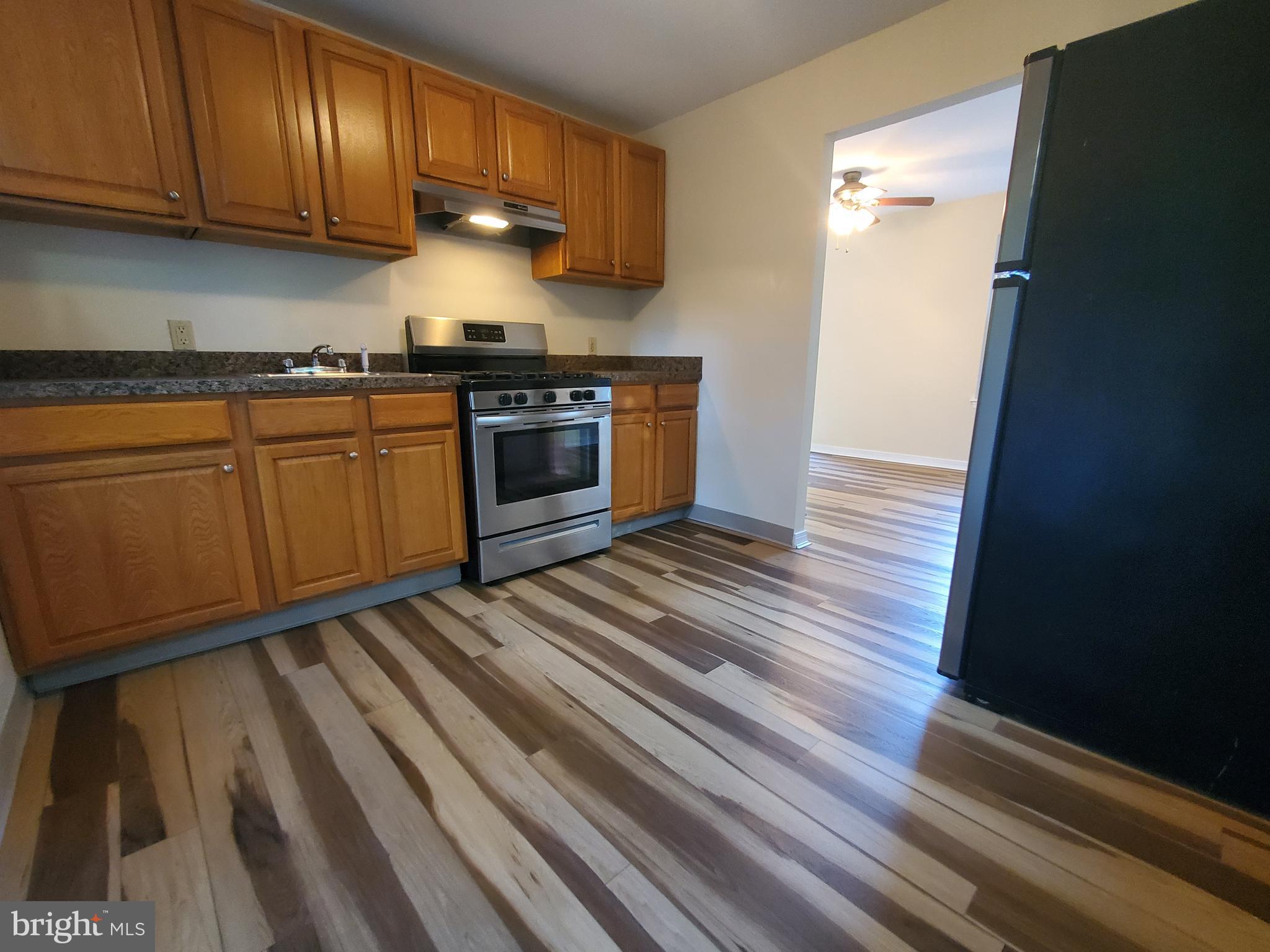 813 Hickory Avenue Browns Mills, NJ 08015 - Photo 2 of 13 a kitchen with granite countertop wooden cabinets and a stainless steel appliances