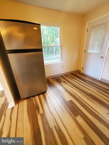 a view of a room with a wooden floor