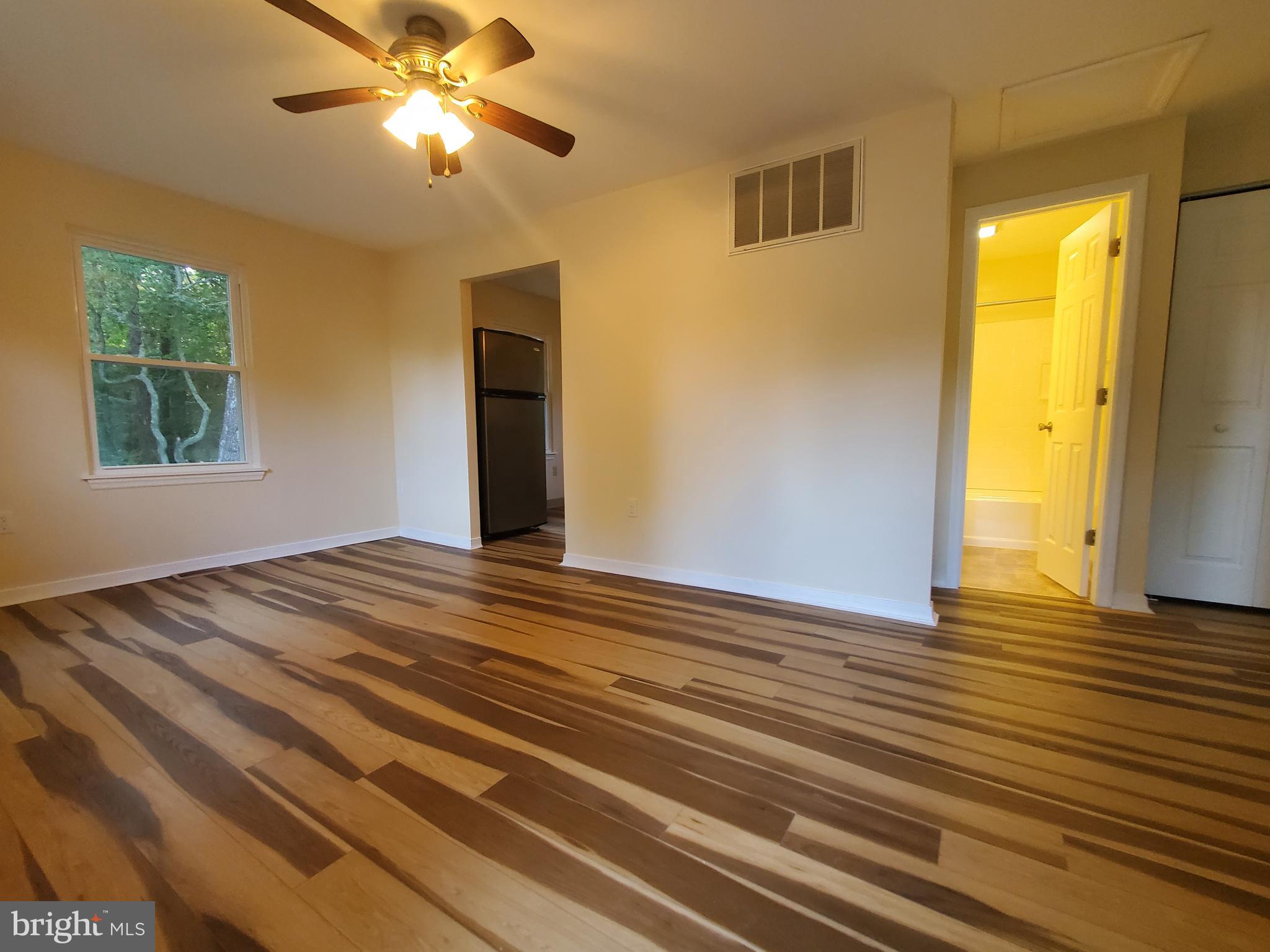 813 Hickory Avenue Browns Mills, NJ 08015 - Photo 7 of 13 a view of empty room with wooden floor and fan