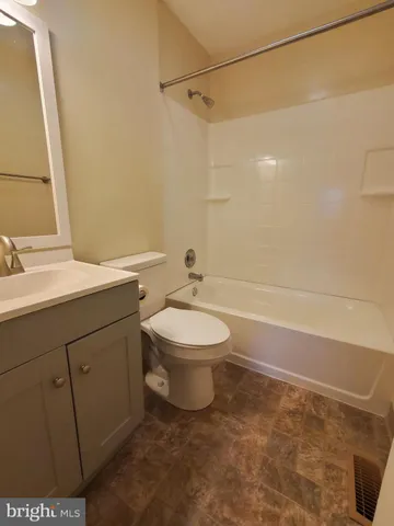 a bathroom with a toilet sink and shower