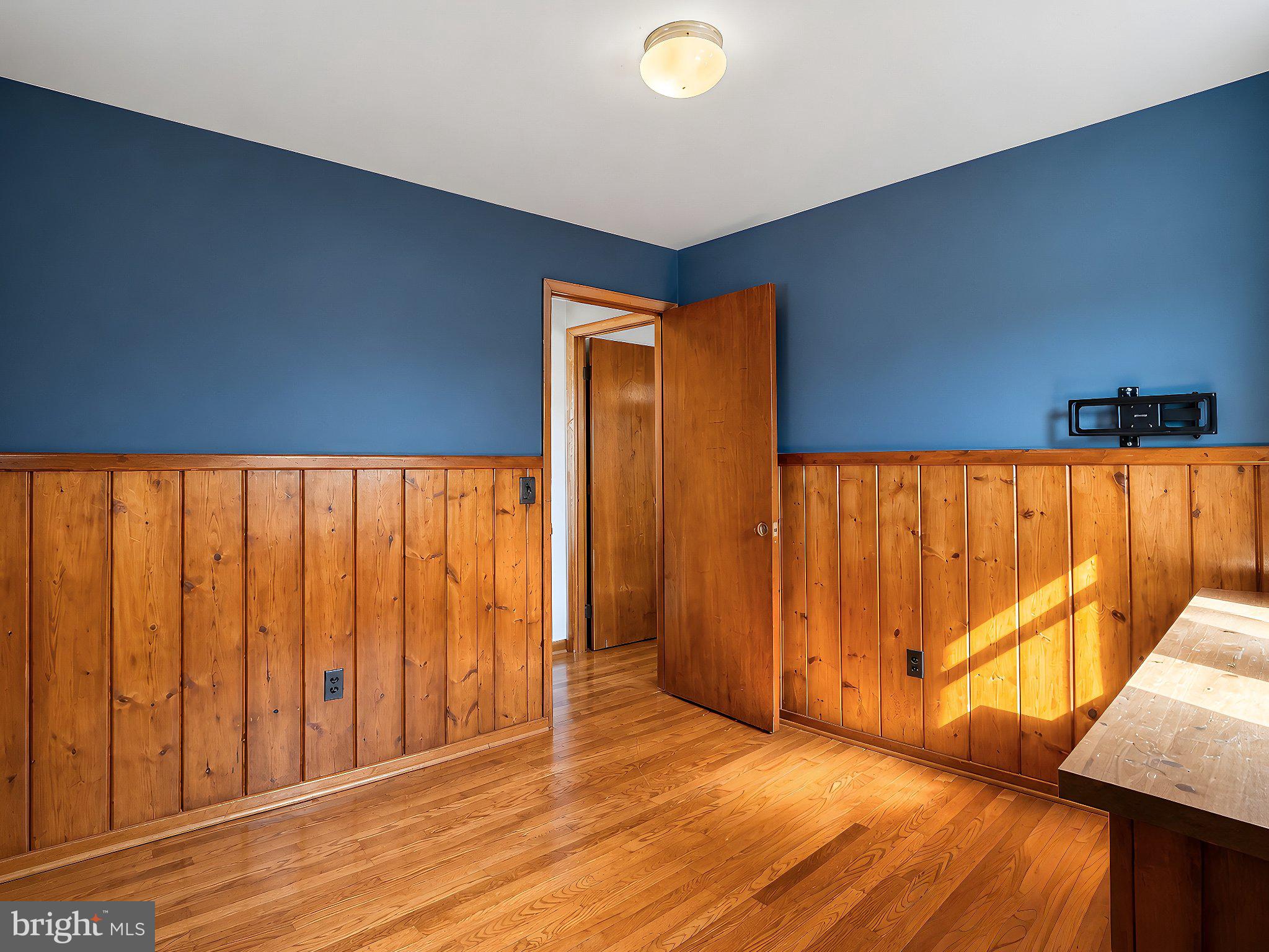13315 Point Lookout Road Ridge, MD 20680 - Photo 27 of 51 Warm wood accents meet vibrant blue walls.
